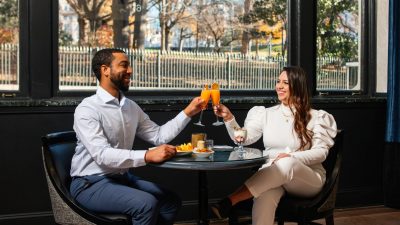 Young man and woman dining at Ruegers