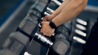 Person grabbing weights for exercise