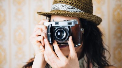 Woman taking photo with film camera